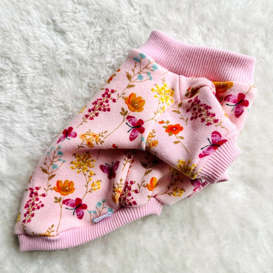 Pink floral dog jacket on a white fluffy surface. made to measure